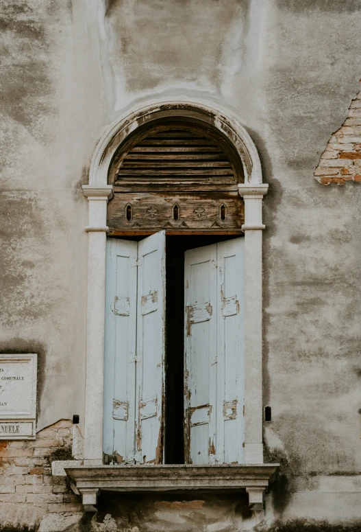 there is an old, open doorway and a sign on a wall