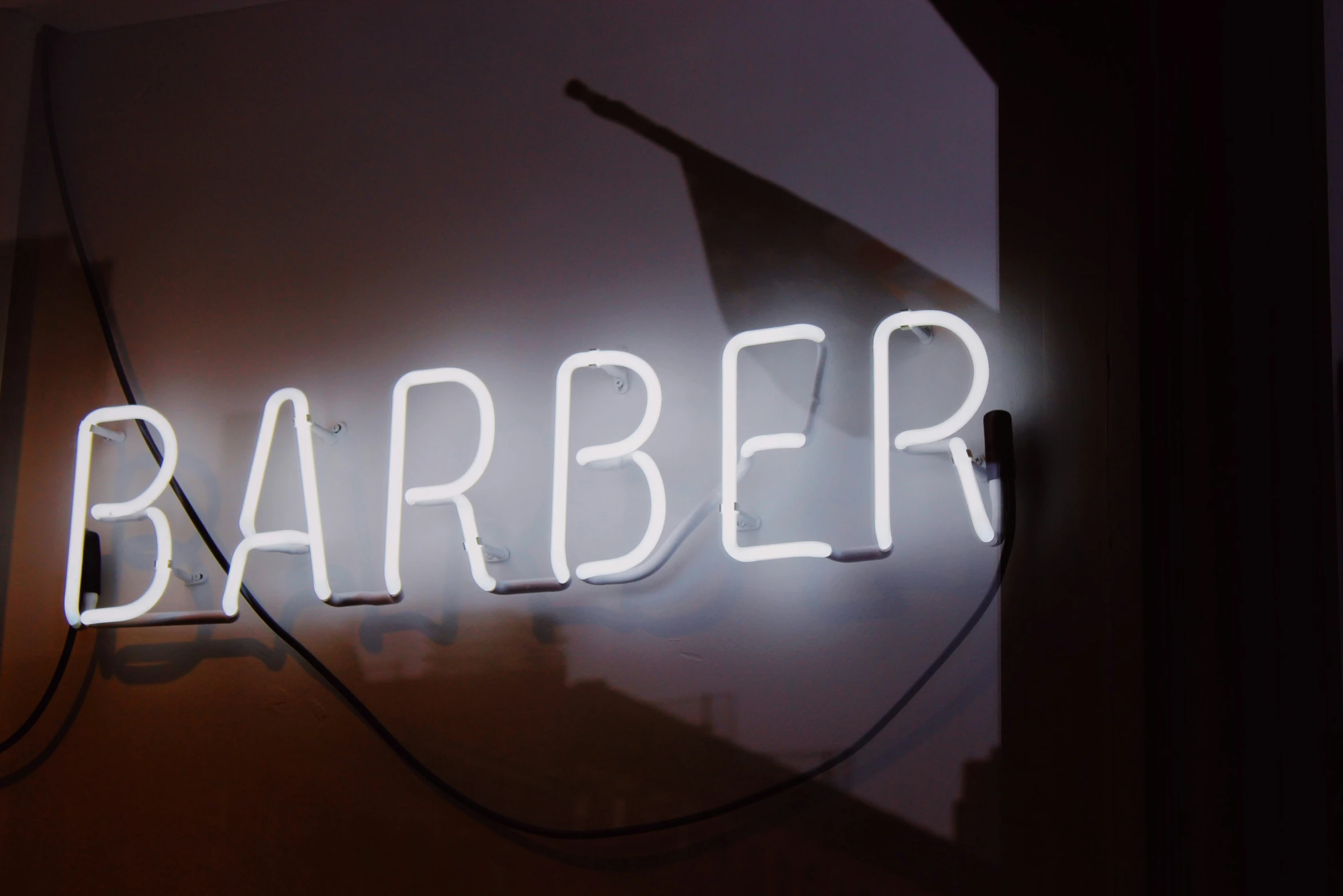 a sign that reads barber sitting in a room