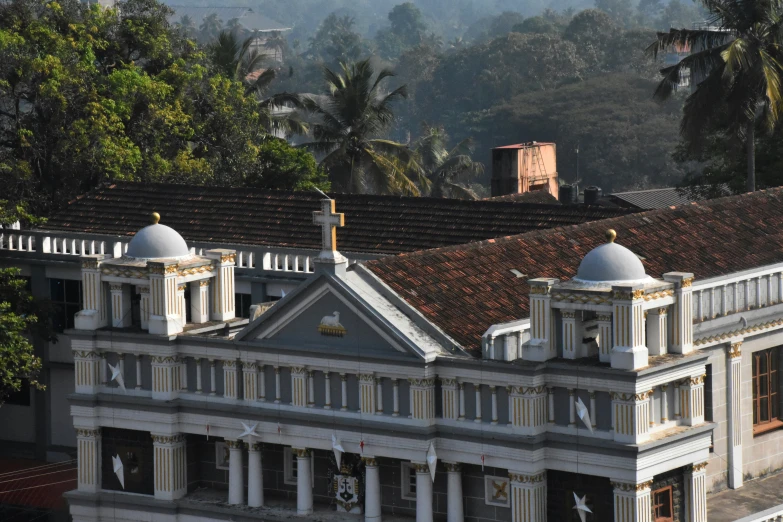 a tall building with white trim and black roof