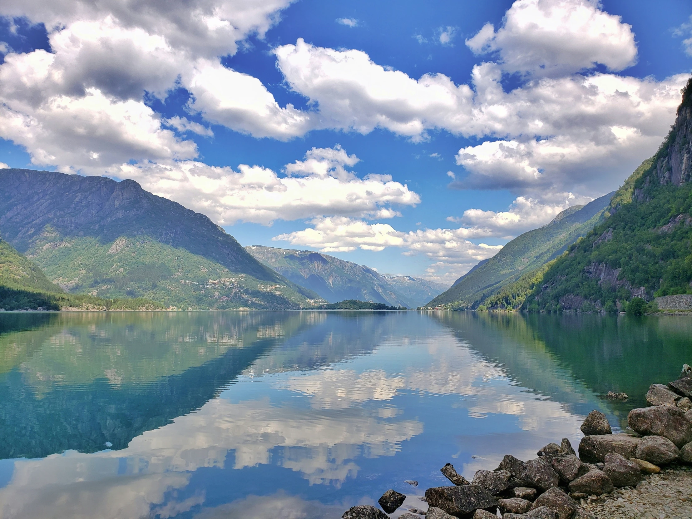 a view of mountains and lake with sky