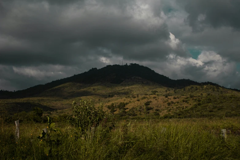 the mountains and trees are silhouetted against cloudy skies