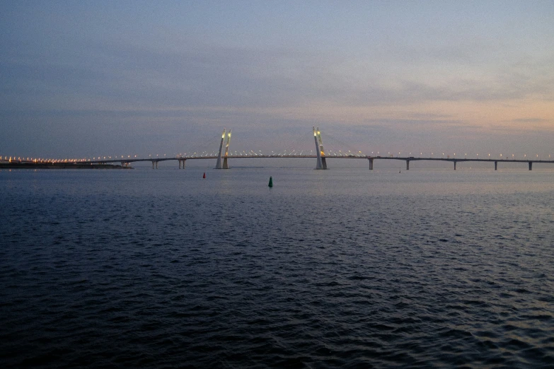 a bridge with several pillars stretches out to sea