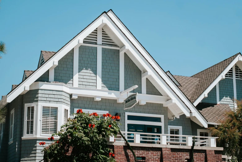 an attractive house with shutters that lead into a balcony