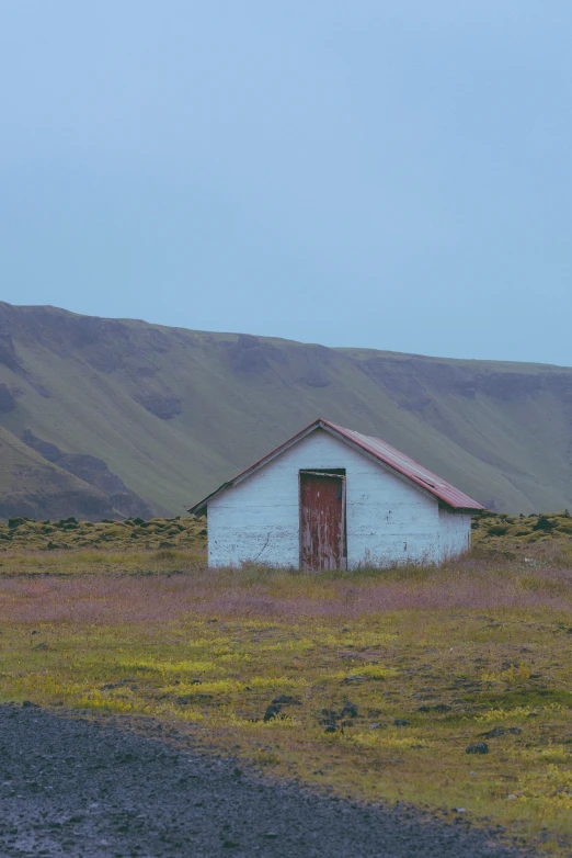 a run down white building with an old door