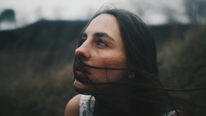 a woman that is standing in the grass