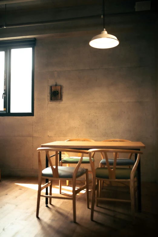 an empty table sits under a window