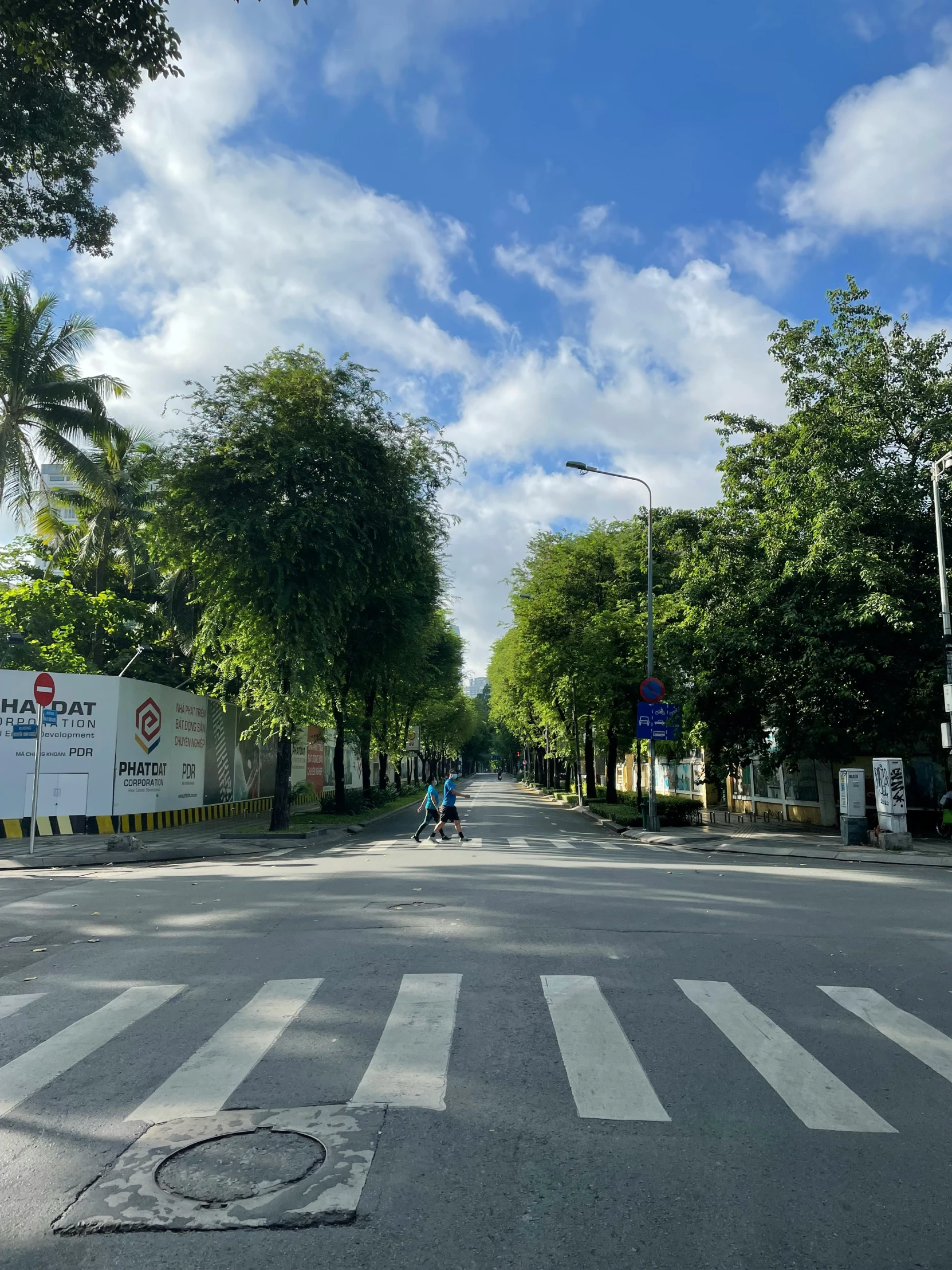 the intersection of an empty road surrounded by trees