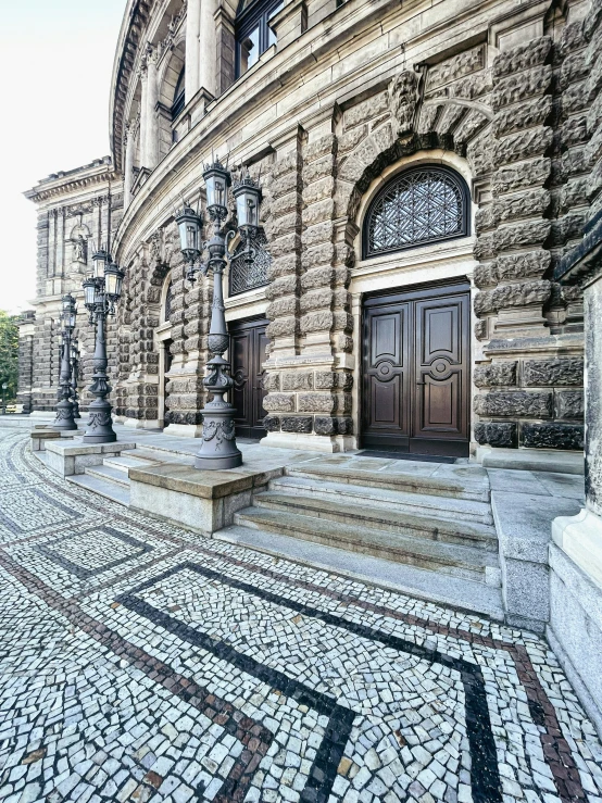 a large building with columns, a door and two windows