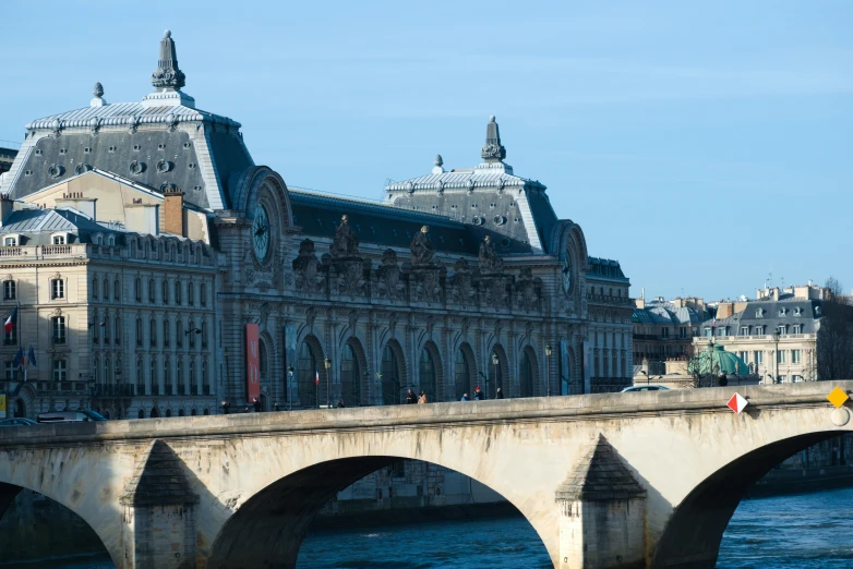 old city building with stone arch bridge over river