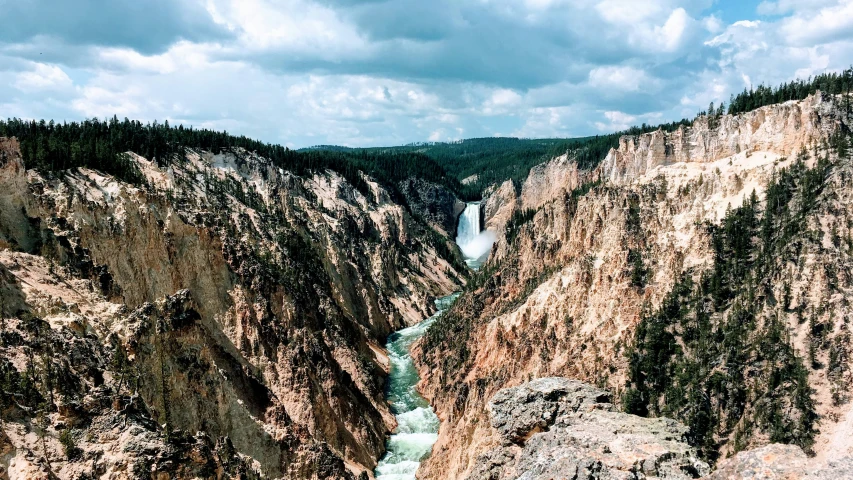 the view of a river and mountains in a valley