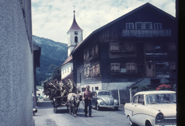 people on street with horses drawn cart in a small town