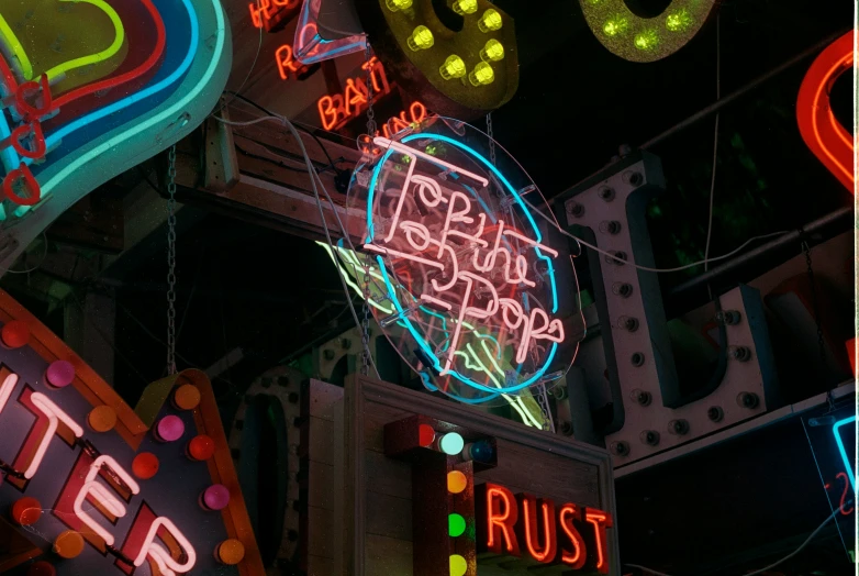 many neon signs all around a building and sign