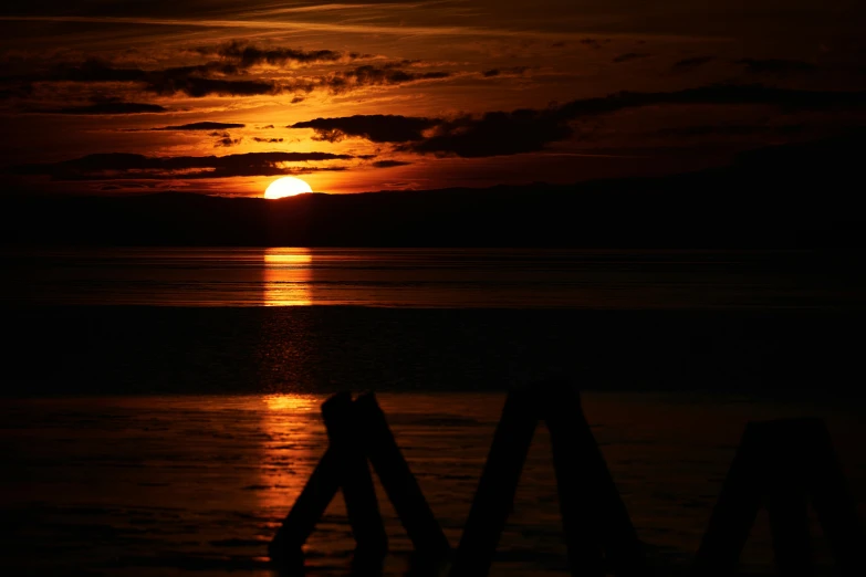 a large red sun shining through the sky