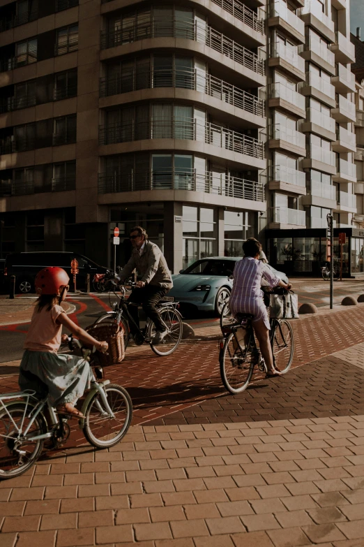 the women are riding bikes with children on back