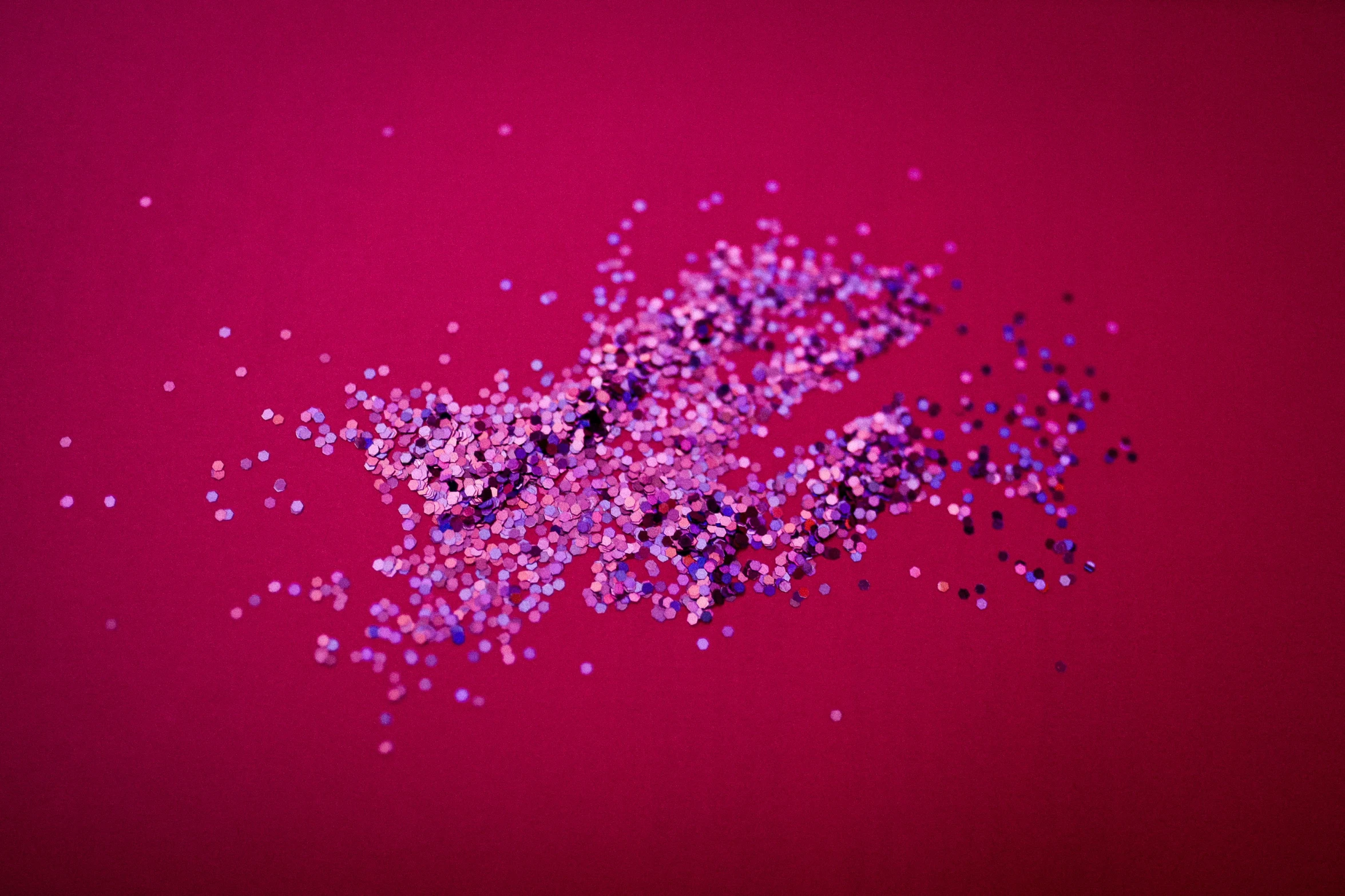 colorful pink confetti scattered on a red background