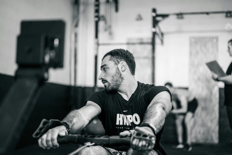 a man on a bench holding a barbell