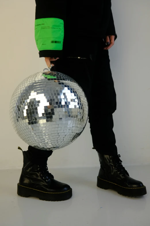 a person with a large disco ball standing next to him