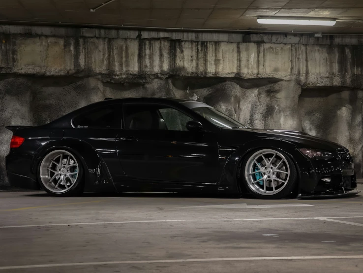 the black car is parked in the parking garage