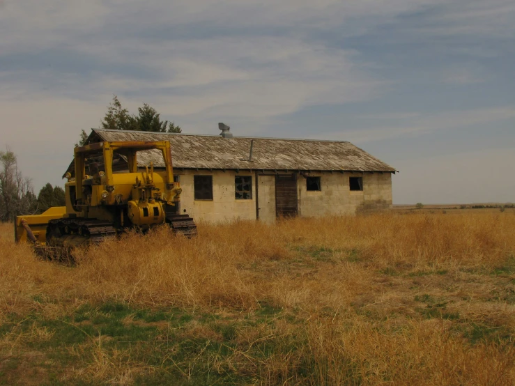 an old, abandoned house in a pasture near the woods