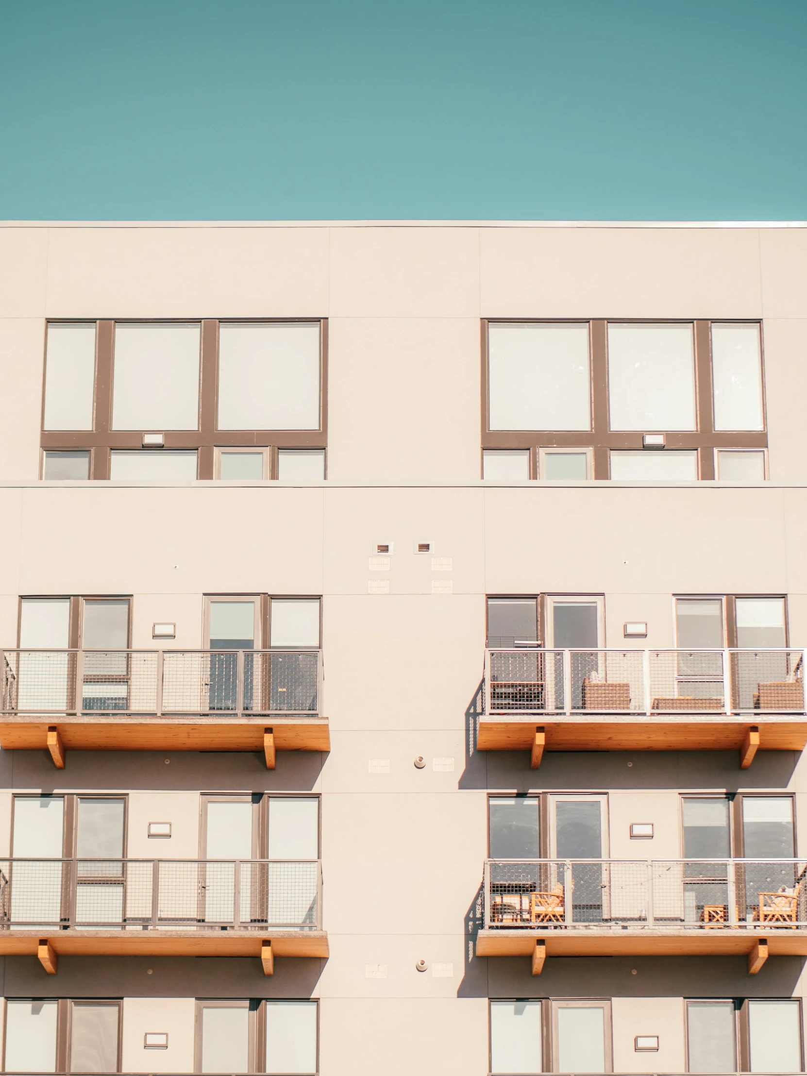 the side of an apartment building with balcony railings and balconies