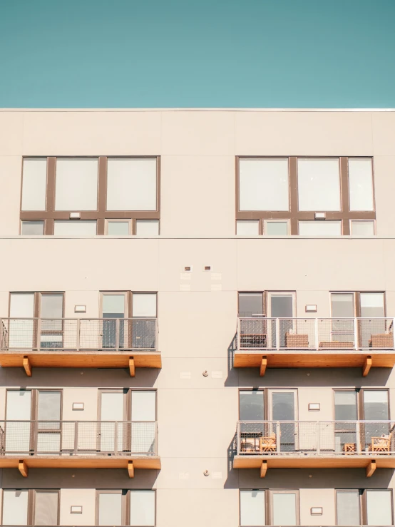 the side of an apartment building with balcony railings and balconies