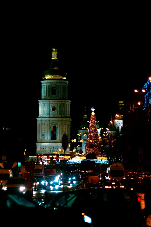 the large clock tower is lit up for christmas