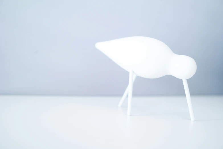 a white object stands upright on a table