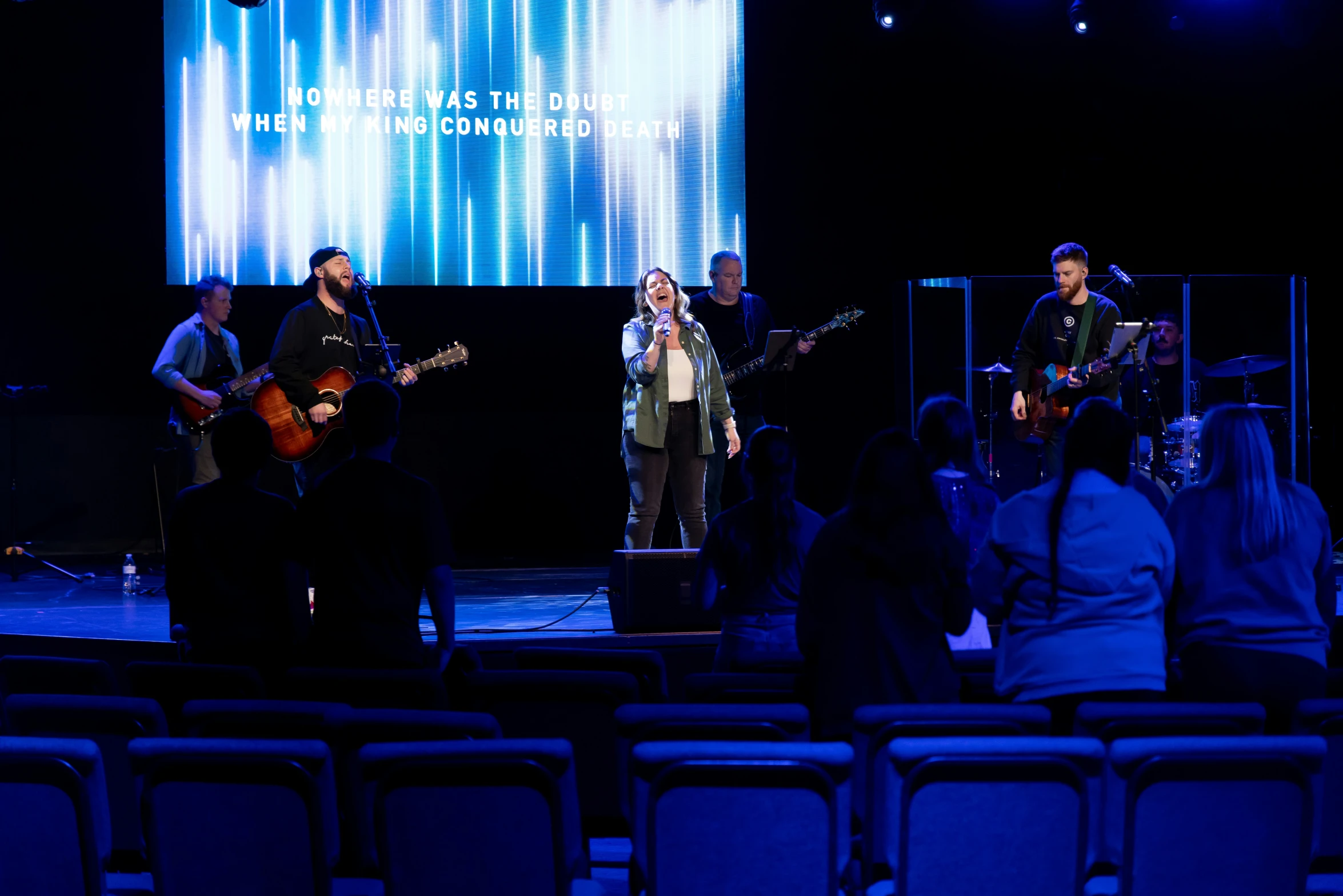 a band performing on a stage while people watch