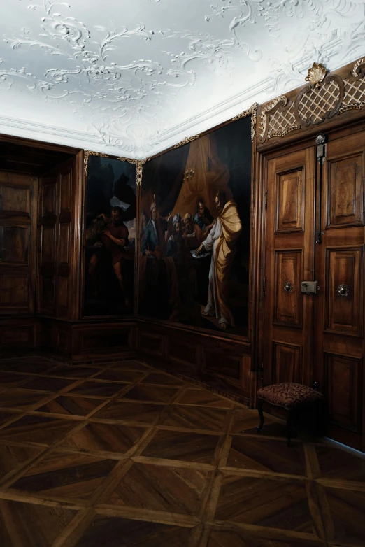 an image of an indoor hallway with paintings