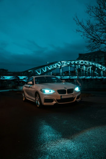 a white bmw car parked at the end of the road