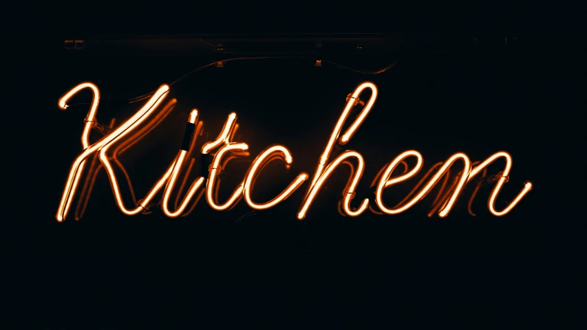 lit up sign that reads kitchen on the wall