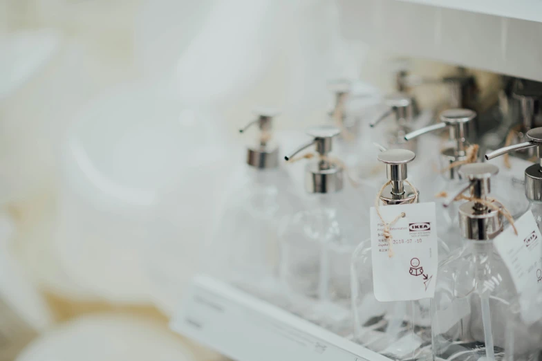 a group of different bottles that are under a mirror