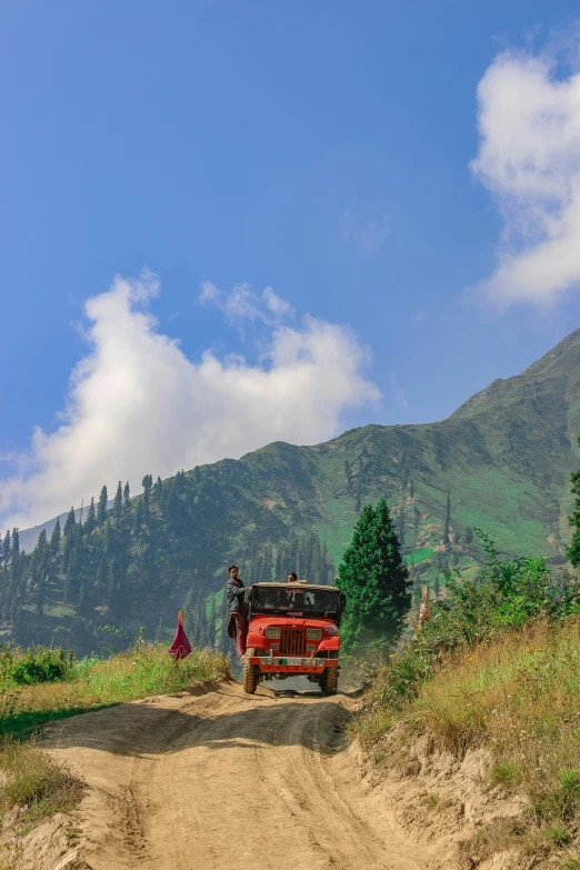 a dirt road and a van in the background