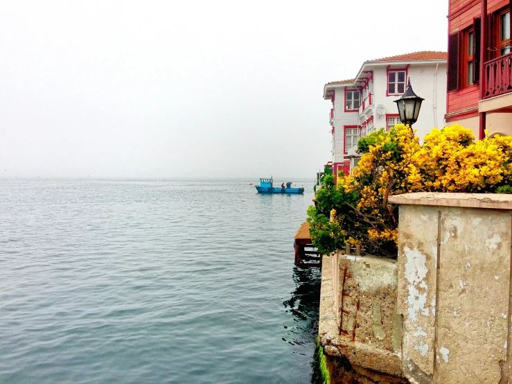 a boat in the water next to two colorful houses