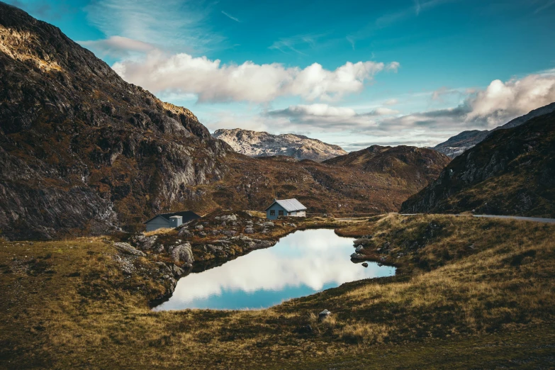 a blue water body of water on a hilly slope