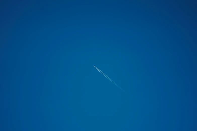 there is an airplane that has it's tails flying across the blue sky
