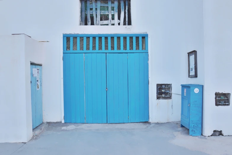 a bright blue entrance to a white building