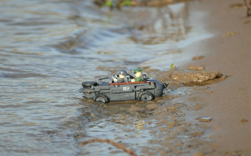 a toy boat floating in a body of water