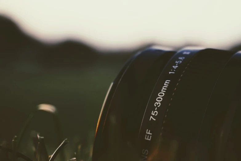 two camera lenses laying on the ground close to each other