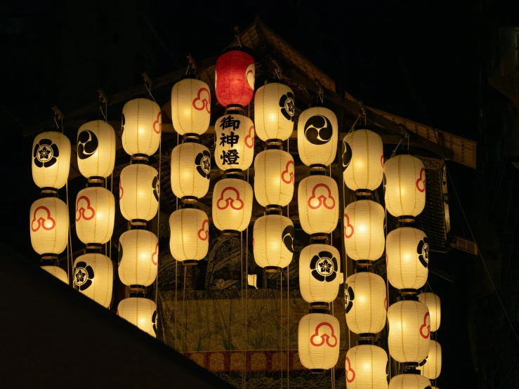 many paper lanterns are lit in the dark
