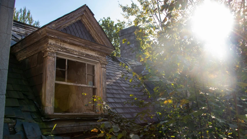 a wooden window with sun coming out