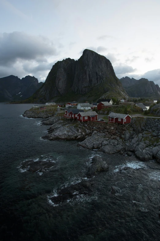 a group of buildings sitting on top of a rocky beach