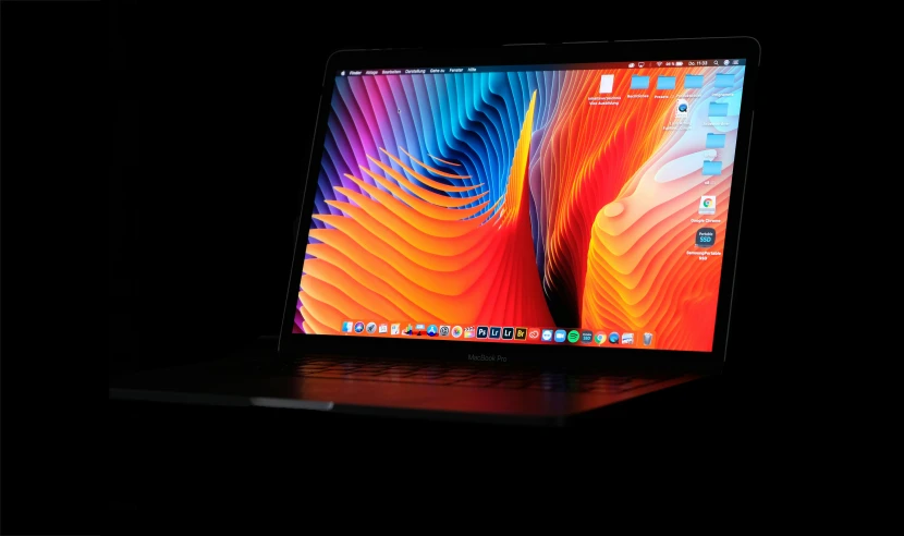 an apple macbook pro laptop with a colorful abstract pattern