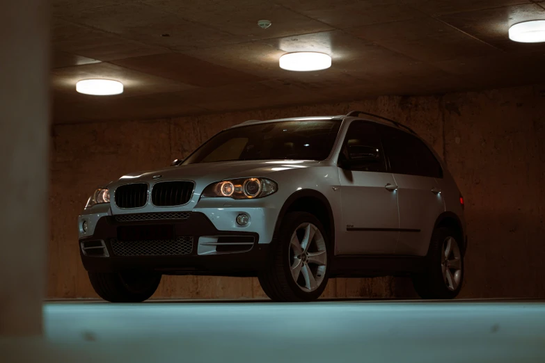 an suv is parked under lights in a car park