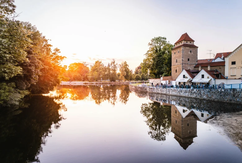 a sunset reflects on the still water in this european village