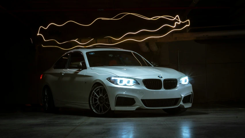 a bmw is sitting in front of the lights