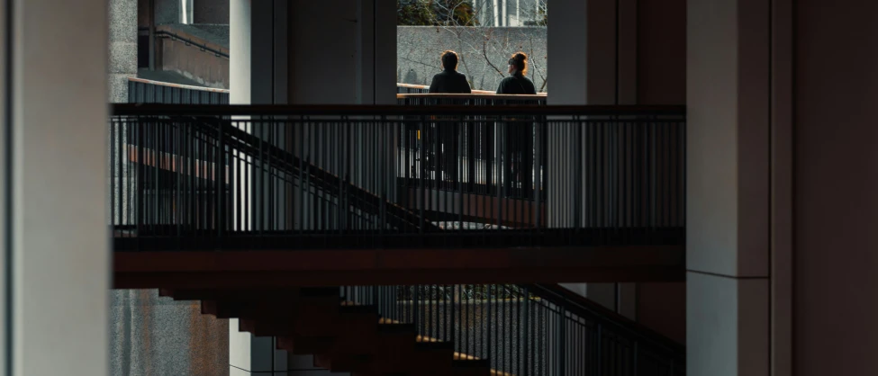 people walking on a staircase next to a set of stairs