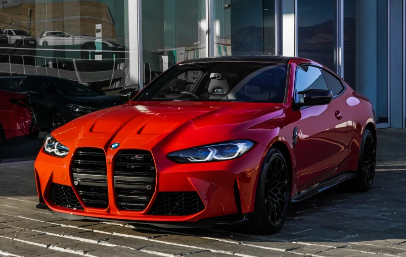 an orange sports car parked near a building