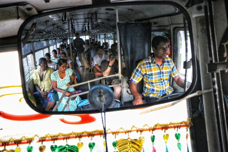 many people are inside a bus with colorful decoration