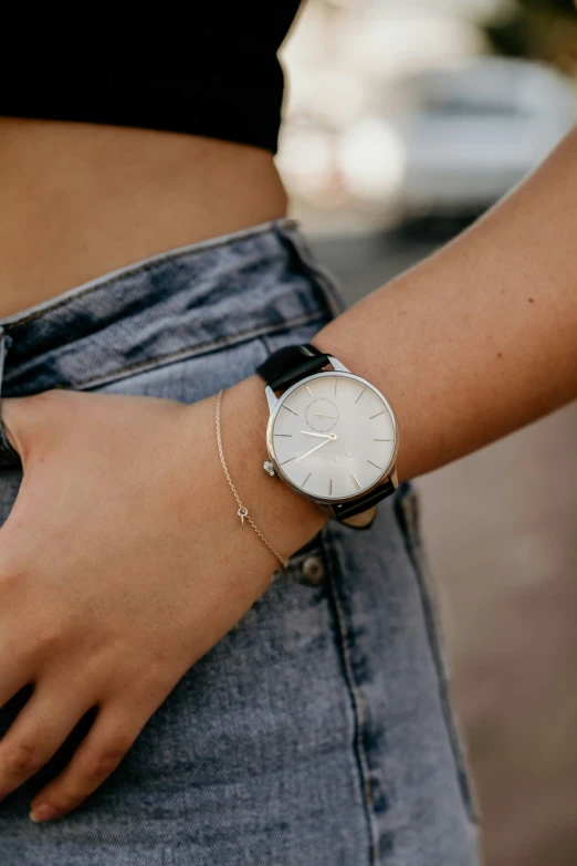 a woman wearing a silver watch on her wrist